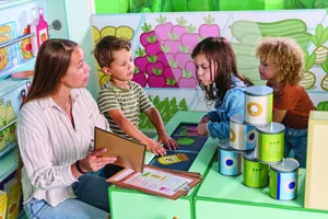 An adult teaching 3 children at PEPPA PIG World of Play