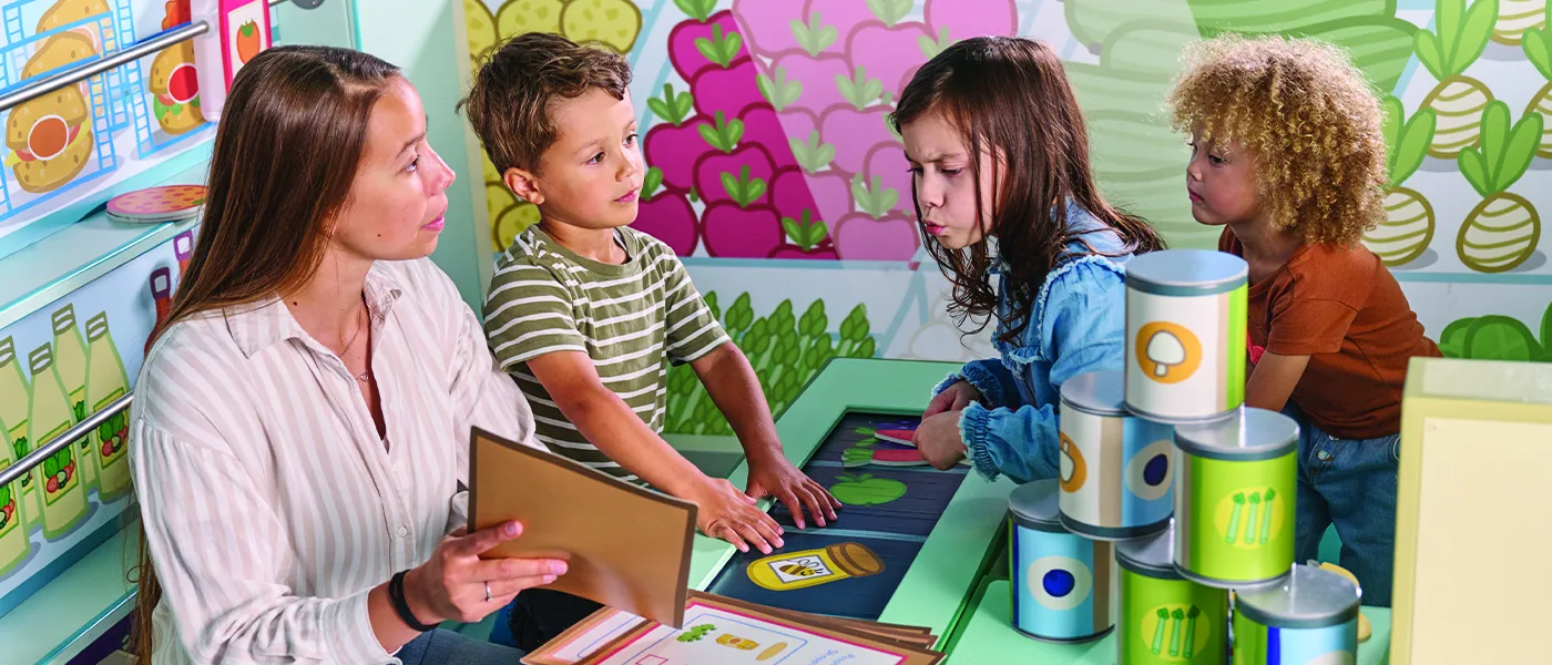 Adult teaching three children at PEPPA PIG World of Play