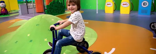 Kid riding a tricycle