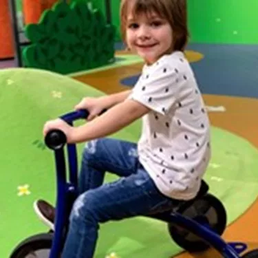 Kid riding a tricycle