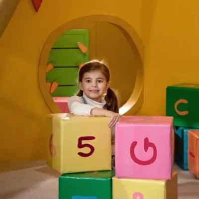 Girl hiding behind blocks