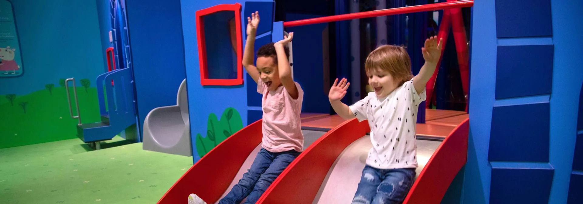 Kids sliding down a slide