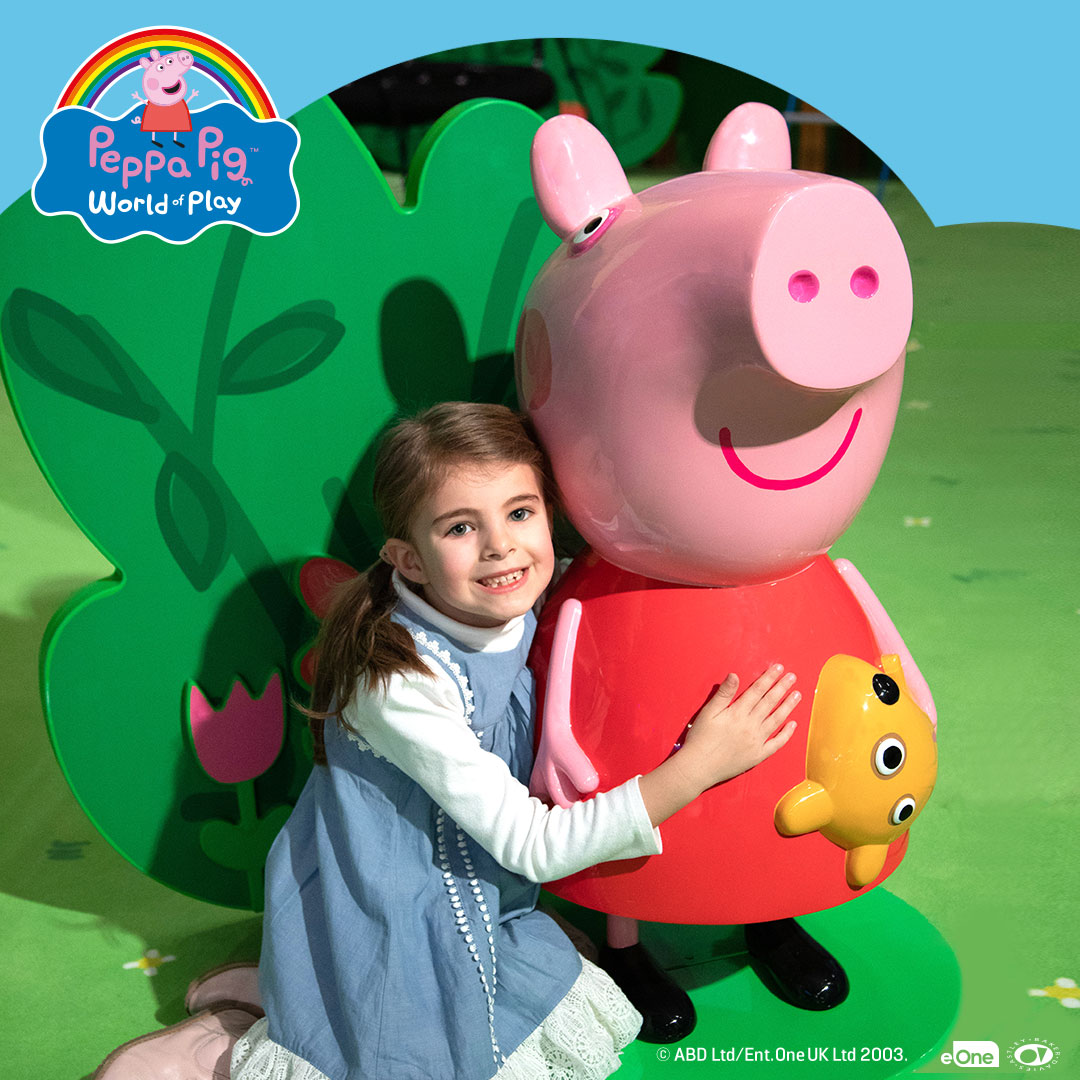 Girl hugging George the Pig