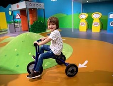 Kid riding a tricycle
